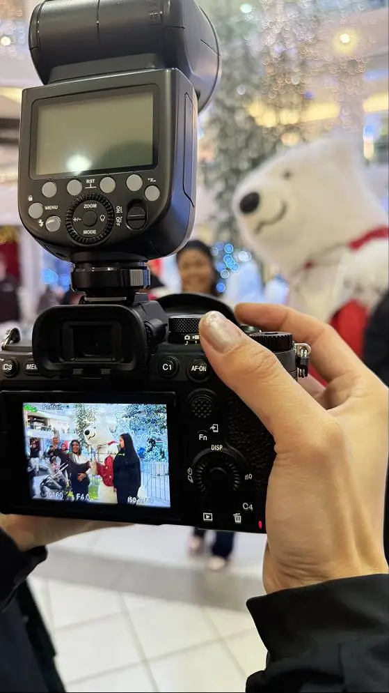 Camera capturing festive scene indoors.