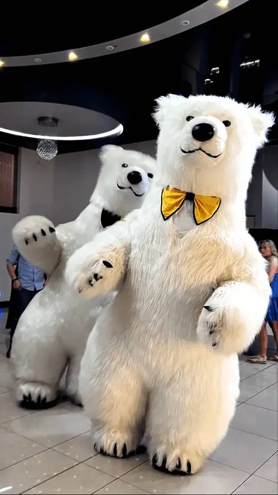 Two polar bear costumes dancing.