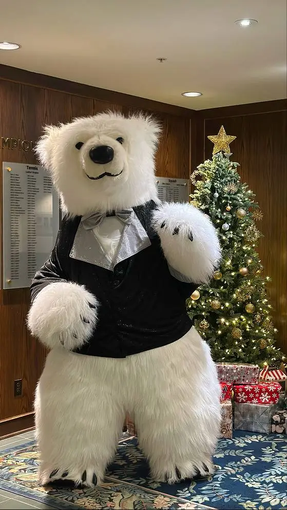 Polar bear in tuxedo by tree