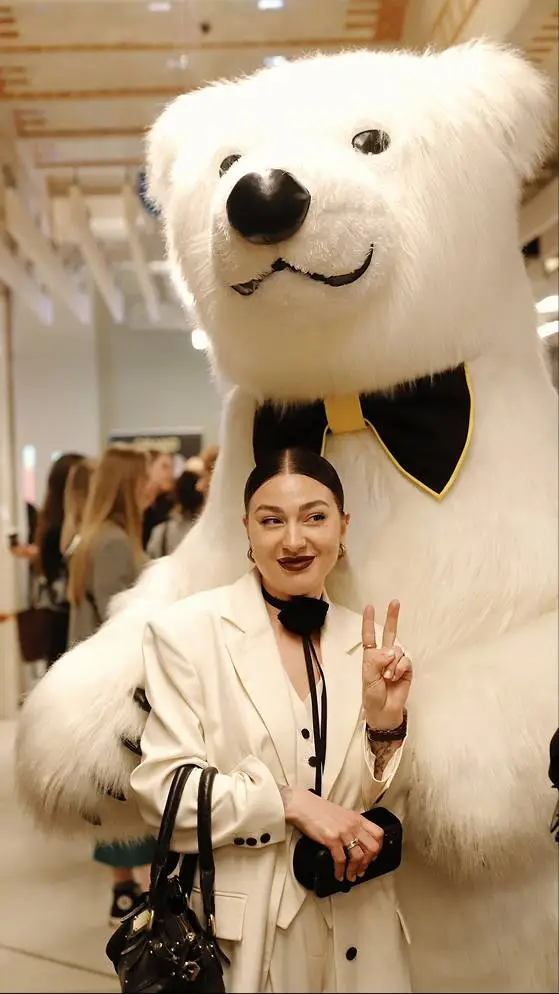 Person posing with a polar bear.