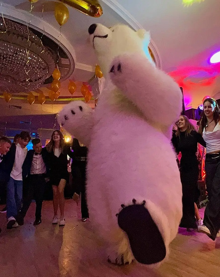Polar bear mascot dancing at a private party in Vancouver with guests