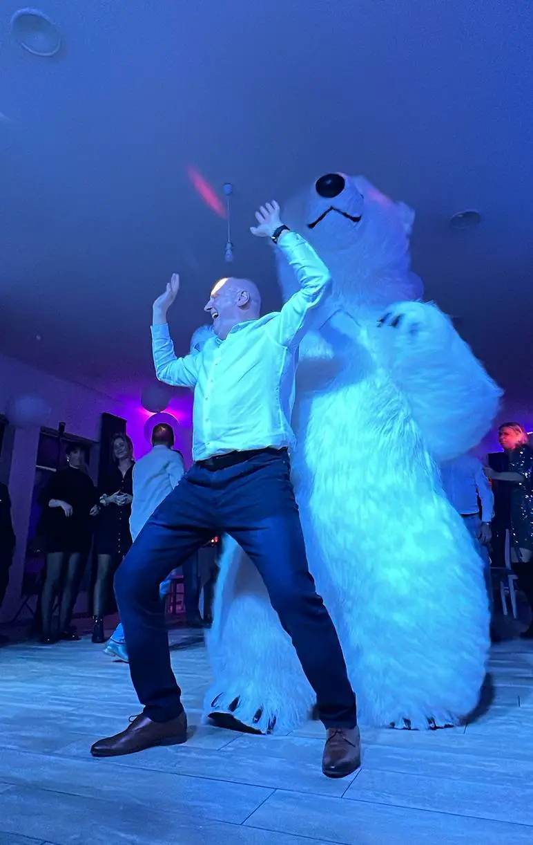 Polar bear party entertainment in Vancouver featuring a guest dancing with a life-size polar bear mascot at a private event