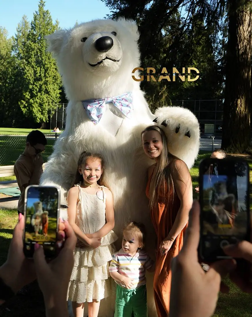 Polar bear mascot holding balloons during a birthday surprise party in Vancouver