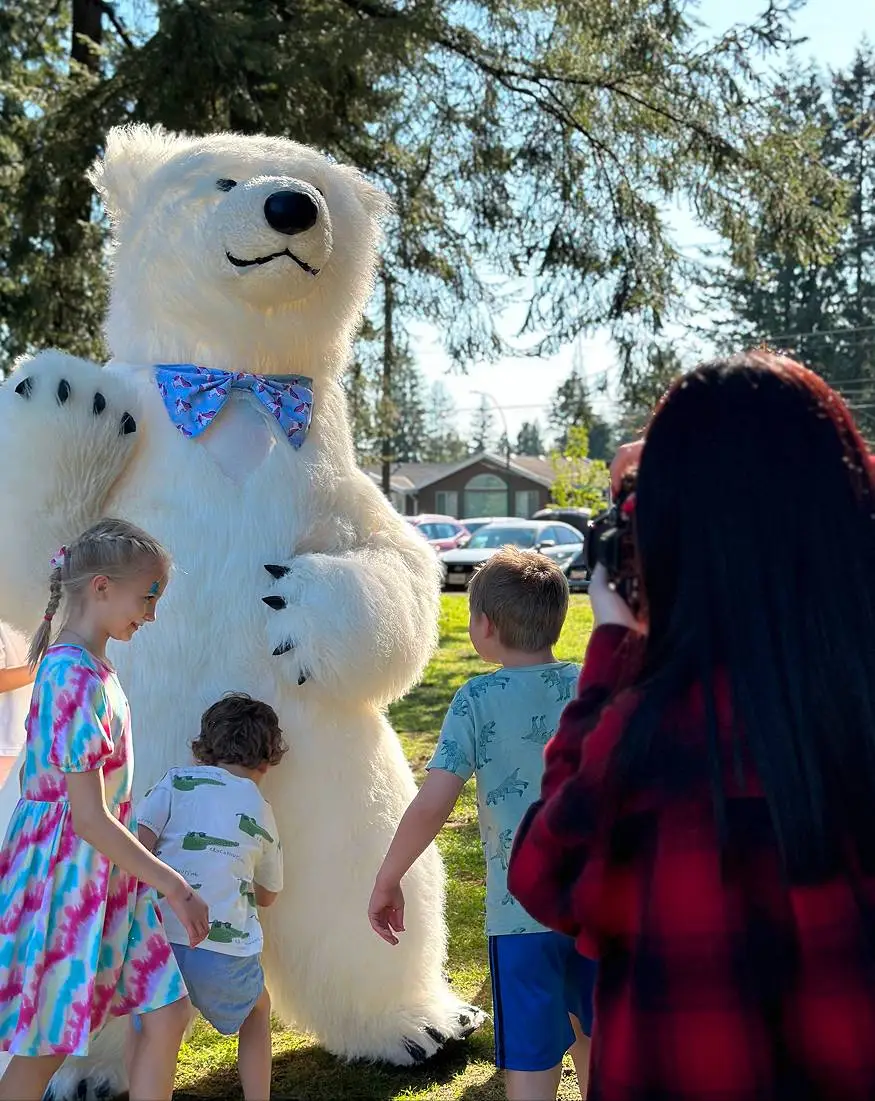 Polar bear mascot entertaining children at an outdoor kids party in Vancouver
