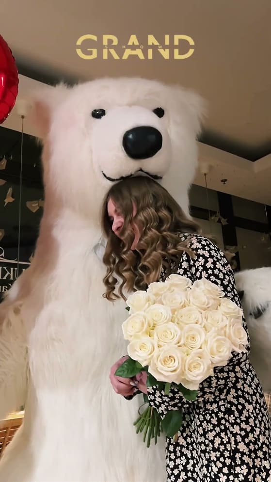 Woman with flowers and polar bear.
