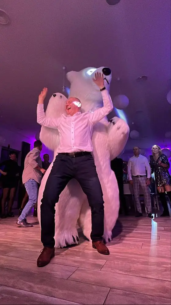Men dancing with a polar bear at a corporate event in Vancouver