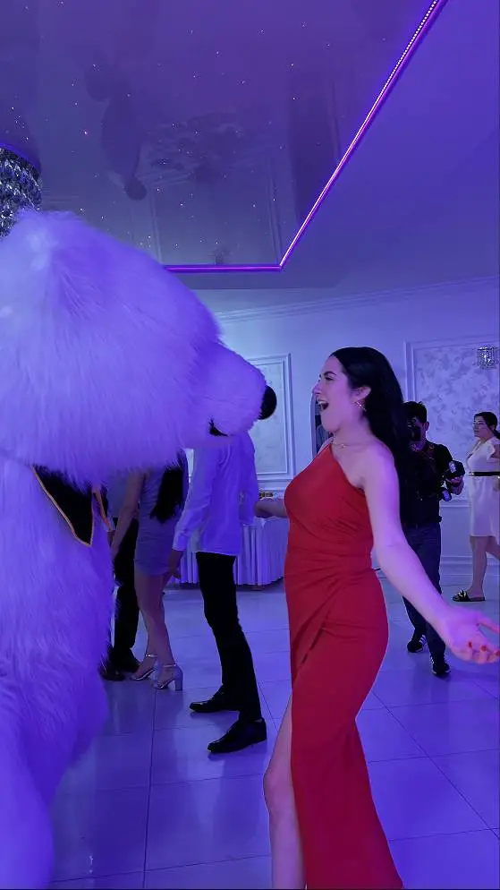 Woman in red dress with polar bear